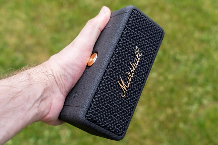 Holding the Marshall Emberton II in hand.