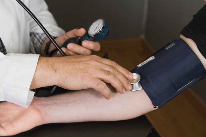 Checking blood pressure of a person.